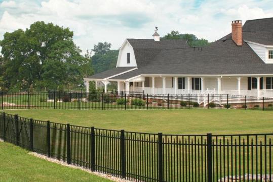 Keylink aluminum fence around a white house