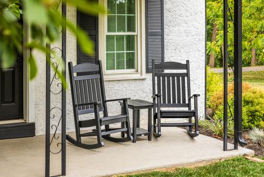 rocking chairs with end table on farmhouse porch