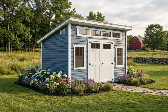 studio shed with blue vinyl siding and dark metal roof